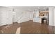 Inviting living room with hardwood floors, staircase, and seamless connection to the kitchen at 8777 Whiteclover St, Littleton, CO 80125