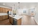 Bright, open-concept living area with hardwood floors, flowing into a modern kitchen at 8777 Whiteclover St, Littleton, CO 80125