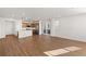 Spacious living room with hardwood floors and an open concept layout, leading to the kitchen at 8777 Whiteclover St, Littleton, CO 80125