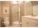 Bright bathroom featuring a vanity with storage and glass-enclosed shower at 10018 E 62Nd Ave, Denver, CO 80238