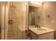 Bathroom featuring vanity with solid-surface counter and glass shower enclosure at 10018 E 62Nd Ave, Denver, CO 80238