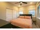Bedroom features sliding door closet, windows, ceiling fan and neutral paint at 10018 E 62Nd Ave, Denver, CO 80238