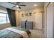 Bedroom with neutral color scheme, slider closet, and large window at 10018 E 62Nd Ave, Denver, CO 80238