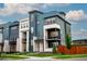 Contemporary three-story townhome featuring a modern design and stylish curb appeal at 10018 E 62Nd Ave, Denver, CO 80238