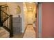 Hallway features a stairwell, coat closet, decor and access to the home's entry at 10018 E 62Nd Ave, Denver, CO 80238