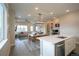 Open concept living area features a modern kitchen, dining space, and comfortable living room at 10018 E 62Nd Ave, Denver, CO 80238