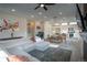 Comfortable living room with an L-shaped couch, an open kitchen, and an adjacent dining area at 10018 E 62Nd Ave, Denver, CO 80238