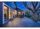 Spacious wooden deck, outdoor dining set, grill, and string lights creating an inviting backyard space at 13076 Marion Dr, Thornton, CO 80241