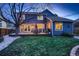 Charming backyard with a spacious deck, lush green grass, and ambient string lighting for evening enjoyment at 13076 Marion Dr, Thornton, CO 80241
