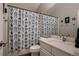 Bathroom featuring a single vanity with marble countertops and a shower with modern shower curtain at 13076 Marion Dr, Thornton, CO 80241
