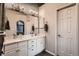 Bathroom featuring a double vanity with marble countertops, stylish lighting, and a neutral color scheme at 13076 Marion Dr, Thornton, CO 80241