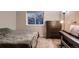 Comfortable bedroom with a dresser, window, and soft lighting, creating a relaxing atmosphere at 13076 Marion Dr, Thornton, CO 80241