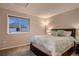 Comfortable bedroom with neutral walls, plush carpet, a soft queen bed, and an exterior window view at 13076 Marion Dr, Thornton, CO 80241