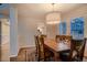 Cozy dining room with hardwood floors and a seamless transition to the kitchen, perfect for Gathering meals at 13076 Marion Dr, Thornton, CO 80241