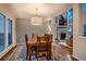Elegant dining room featuring a wooden table, a large chandelier, and a view of the living room at 13076 Marion Dr, Thornton, CO 80241