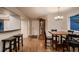 Inviting dining room with hardwood floors, a traditional grandfather clock, and stylish barstool seating at 13076 Marion Dr, Thornton, CO 80241