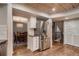 Modern kitchen featuring stainless steel appliances, white cabinets, and a seamless flow into the dining area at 13076 Marion Dr, Thornton, CO 80241