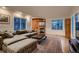 Bright living room showcasing a fireplace, built-in shelves, and lots of natural light from large windows at 13076 Marion Dr, Thornton, CO 80241
