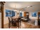 Bright and airy living room with hardwood floors, a cozy fireplace, and large windows offering ample natural light at 13076 Marion Dr, Thornton, CO 80241