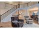 Inviting living room showcasing an open floorplan with hardwood floors and a modern staircase at 13076 Marion Dr, Thornton, CO 80241