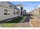 Exterior view showing the patio, balcony and landscaped backyard with rocks and artificial turf at 6400 Barnstead Dr, Castle Pines, CO 80108