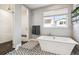 Elegant bathroom with soaking tub and walk-in shower offers a luxurious and relaxing experience at 6400 Barnstead Dr, Castle Pines, CO 80108