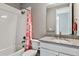 Bathroom featuring granite countertop vanity and a bathtub with pink shower curtain at 6400 Barnstead Dr, Castle Pines, CO 80108