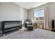 Bedroom with a dark green crib, grey rocking chair with ottoman, and patterned curtains at 6400 Barnstead Dr, Castle Pines, CO 80108