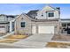 Charming two-story home featuring a stone facade, two-car garage and inviting curb appeal at 6400 Barnstead Dr, Castle Pines, CO 80108