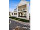 Exterior view of two story home with covered patio and balcony, rock landscaping and artificial turf at 6400 Barnstead Dr, Castle Pines, CO 80108