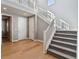 Bright foyer featuring a staircase, hardwood floors, and neutral walls at 6400 Barnstead Dr, Castle Pines, CO 80108