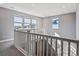 Upstairs hallway with a railing and natural light showcases the home's design at 6400 Barnstead Dr, Castle Pines, CO 80108