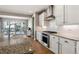 Modern kitchen featuring granite countertops, white cabinets, stainless steel appliances, and hardwood flooring at 6400 Barnstead Dr, Castle Pines, CO 80108