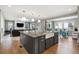 Modern kitchen features a large island with seating and stainless appliances and opens to the living area at 6400 Barnstead Dr, Castle Pines, CO 80108