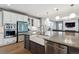 Open-concept kitchen features stainless appliances, large island, and a seamless flow to living area at 6400 Barnstead Dr, Castle Pines, CO 80108