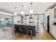 Modern kitchen with a spacious island, stainless steel appliances, and hardwood floors at 6400 Barnstead Dr, Castle Pines, CO 80108