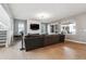 Bright living room featuring hardwood floors, a large couch, and ample natural light at 6400 Barnstead Dr, Castle Pines, CO 80108