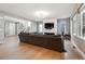 Bright living room featuring hardwood floors, a large couch, and ample natural light at 6400 Barnstead Dr, Castle Pines, CO 80108