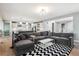 Spacious open-concept living room with modern decor and an adjacent kitchen at 6400 Barnstead Dr, Castle Pines, CO 80108