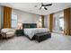 Serene main bedroom featuring a plush bed, seating, and access to a balcony, offering relaxation at 6400 Barnstead Dr, Castle Pines, CO 80108