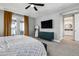 Serene main bedroom featuring a plush bed, seating, and access to a balcony, offering relaxation at 6400 Barnstead Dr, Castle Pines, CO 80108