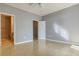 Empty bedroom featuring wood-look floors and neutral-colored walls with access to an attached bathroom and walk-in closet at 7440 S Blackhawk St # 12-204, Englewood, CO 80112