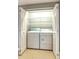 Laundry room featuring a stacked washer and dryer and wire shelving at 7440 S Blackhawk St # 12-204, Englewood, CO 80112
