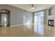 Bright living room featuring a ceiling fan, fireplace, and sliding glass doors at 7440 S Blackhawk St # 12-204, Englewood, CO 80112