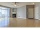 Open-concept living room with fireplace, ceiling fan, and lots of natural light at 7440 S Blackhawk St # 12-204, Englewood, CO 80112