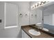 Bathroom with a single sink vanity, bronze fixtures, a large mirror, and neutral wall paint at 162 Blue Spruce Ct, Highlands Ranch, CO 80126