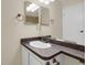 Bathroom with a single sink vanity, bronze fixtures, a large mirror, and neutral wall paint at 162 Blue Spruce Ct, Highlands Ranch, CO 80126