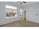 Bedroom with a ceiling fan, neutral paint, an ensuite bathroom, and a large window at 162 Blue Spruce Ct, Highlands Ranch, CO 80126