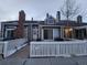 Tan two-story townhome with white picket fence and patio at 162 Blue Spruce Ct, Highlands Ranch, CO 80126