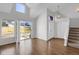 Bright and airy living room with hardwood floors, modern windows, and a staircase at 162 Blue Spruce Ct, Highlands Ranch, CO 80126